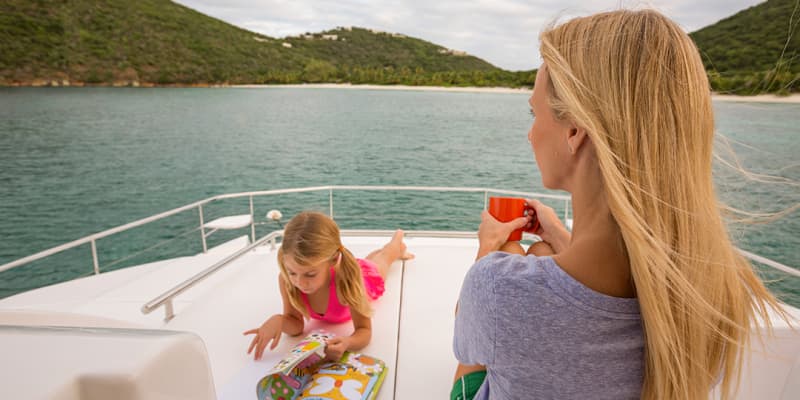 Mother and daughter relaxing on yacht