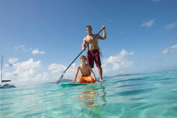 father and son paddle boarding in the BVI