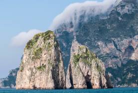 Procida stone boulders in sea