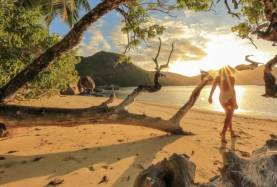 seychelles_woman_walking_beach__2400x1350